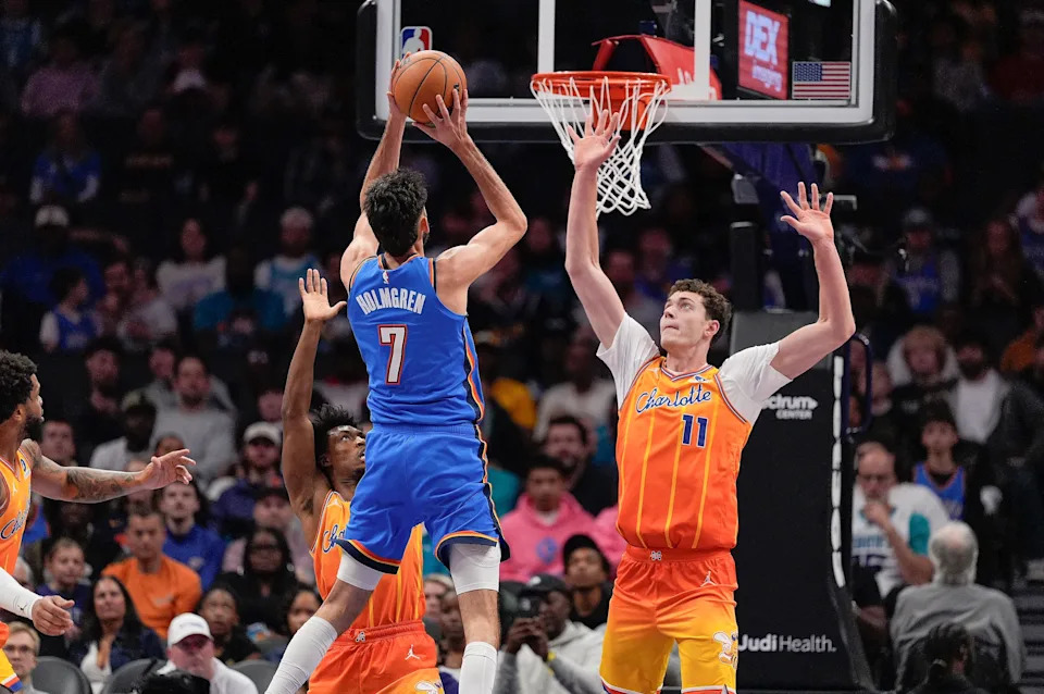 Nov 15, 2025; Charlotte, North Carolina, USA; Oklahoma City Thunder center Chet Holmgren (7) shoots over Charlotte Hornets center Ryan Kalkbrenner (11) during the ffirst half at Spectrum Center. Mandatory Credit: Jim Dedmon-Imagn Images