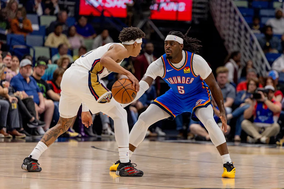 Nov 17, 2025; New Orleans, Louisiana, USA; New Orleans Pelicans guard Jeremiah Fears (0) dribbles against Oklahoma City Thunder guard Luguentz Dort (5) during the first half at Smoothie King Center. Mandatory Credit: Stephen Lew-Imagn Images