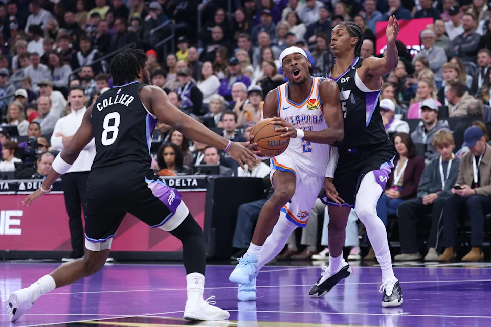 Nov 21, 2025; Salt Lake City, Utah, USA; Oklahoma City Thunder guard Shai Gilgeous-Alexander (2) drives against Utah Jazz guard Isaiah Collier (8) and forward Cody Williams (5) during the first half at Delta Center. Mandatory Credit: Rob Gray-Imagn Images