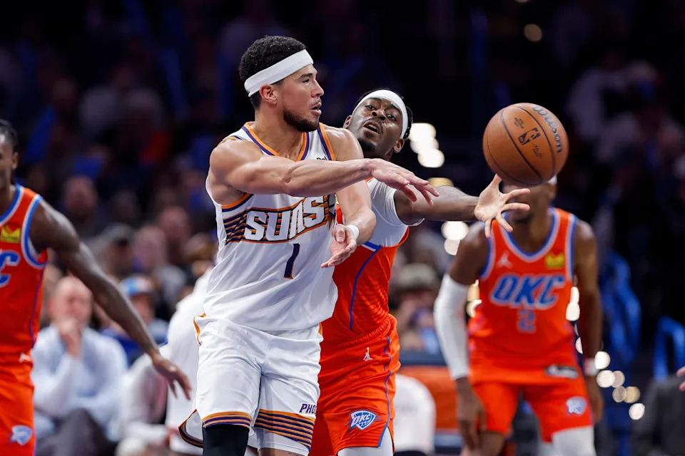 Nov 28, 2025; Oklahoma City, Oklahoma, USAPhoenix Suns guard Devin Booker (1) passes as Oklahoma City Thunder guard Luguentz Dort (5) defends the pass during the second half at Paycom Center. Mandatory Credit: Alonzo Adams-Imagn Images