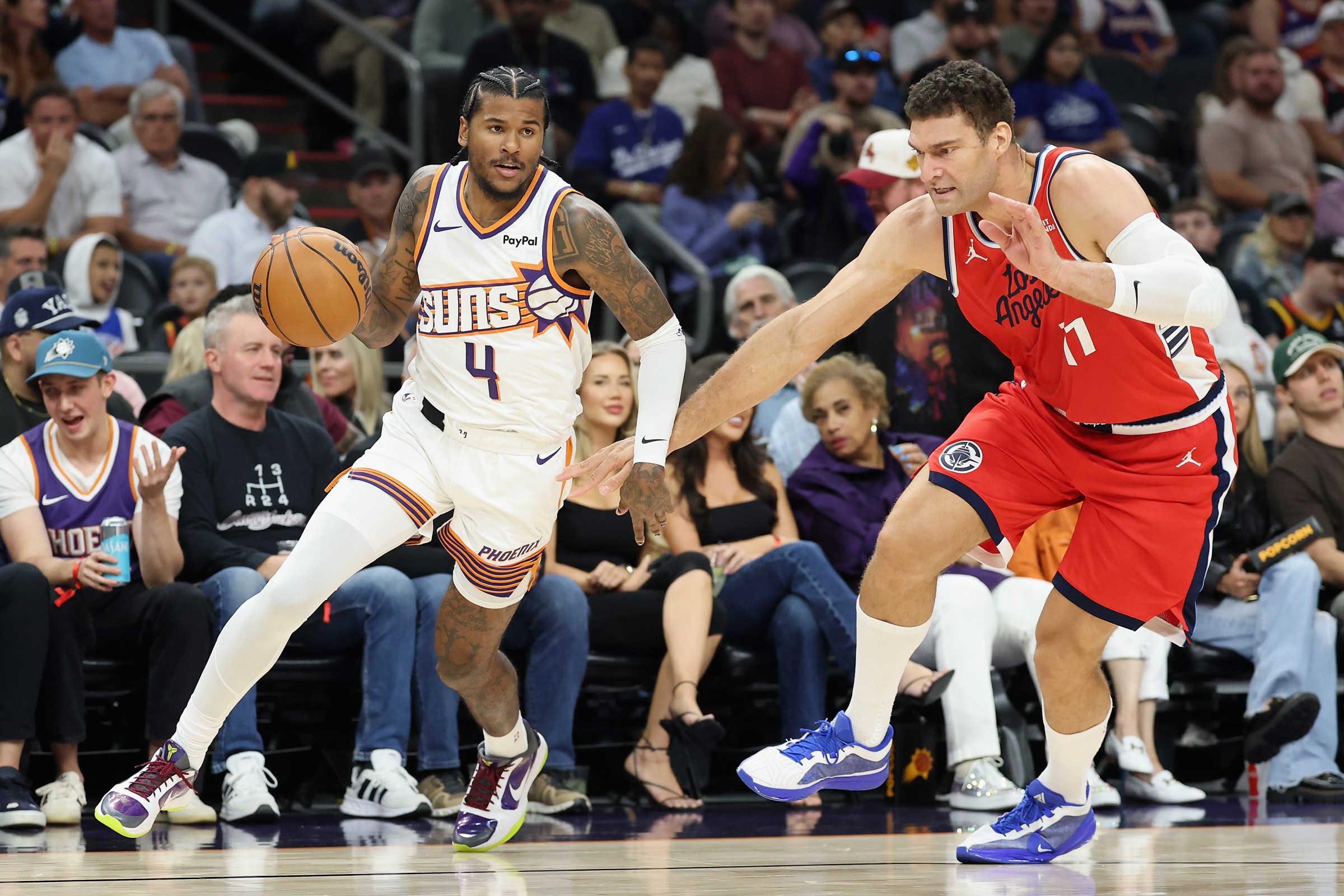 PHOENIX, ARIZONA - NOVEMBER 06: Jalen Green #4 of the Phoenix Suns drives the ball against Brook Lopez #11 of the LA Clippers during the first half of the NBA game at Mortgage Matchup Center on November 06, 2025 in Phoenix, Arizona. NOTE TO USER: User expressly acknowledges and agrees that, by downloading and or using this photograph, user is consenting to the terms and conditions of the Getty Images License Agreement. (Photo by Christian Petersen/Getty Images)