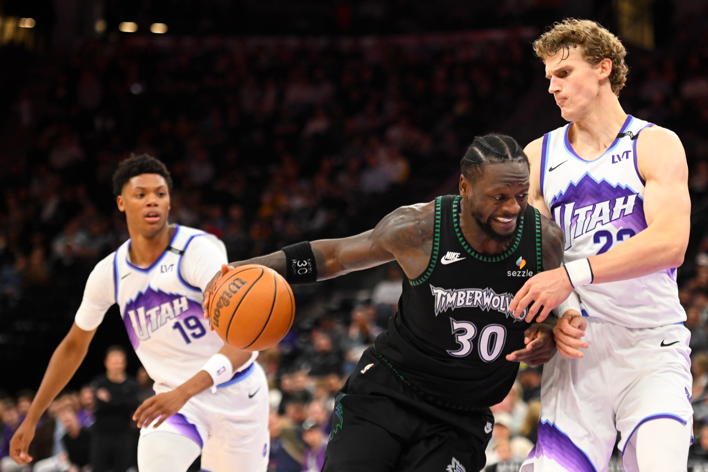 SALT LAKE CITY, UTAH - NOVEMBER 10: Julius Randle #30 of the Minnesota Timberwolves drives against Lauri Markkanen #23 of the Utah Jazz during the second half at Delta Center on November 10, 2025 in Salt Lake City, Utah. NOTE TO USER: User expressly acknowledges and agrees that, by downloading and or using this photograph, User is consenting to the terms and conditions of the Getty Images License Agreement. (Photo by Alex Goodlett/Getty Images)