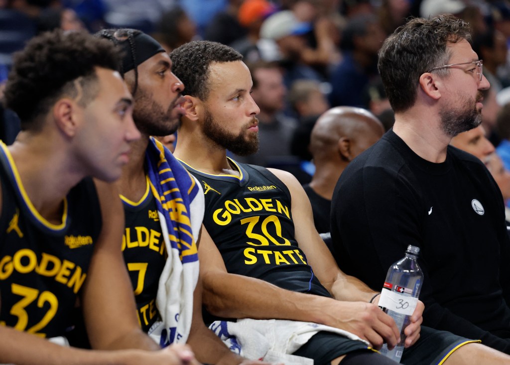 Golden State Warriors guard Stephen Curry (30) watching his team play from the bench.