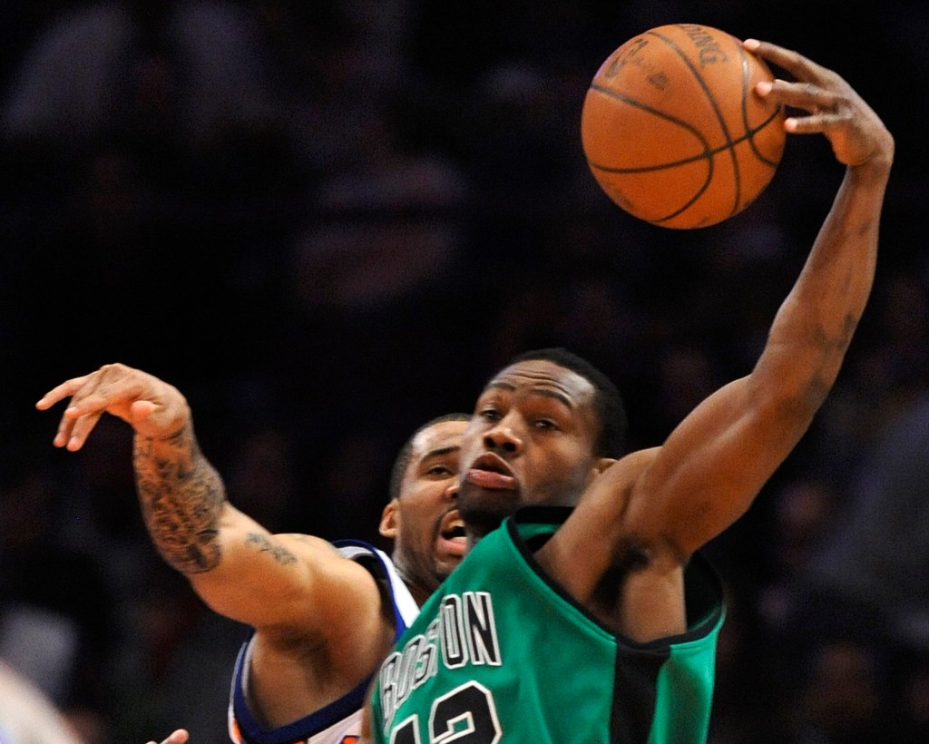 Boston Celtics guard Tony Allen grabbing a rebound over New York Knicks forward Tim Thomas.