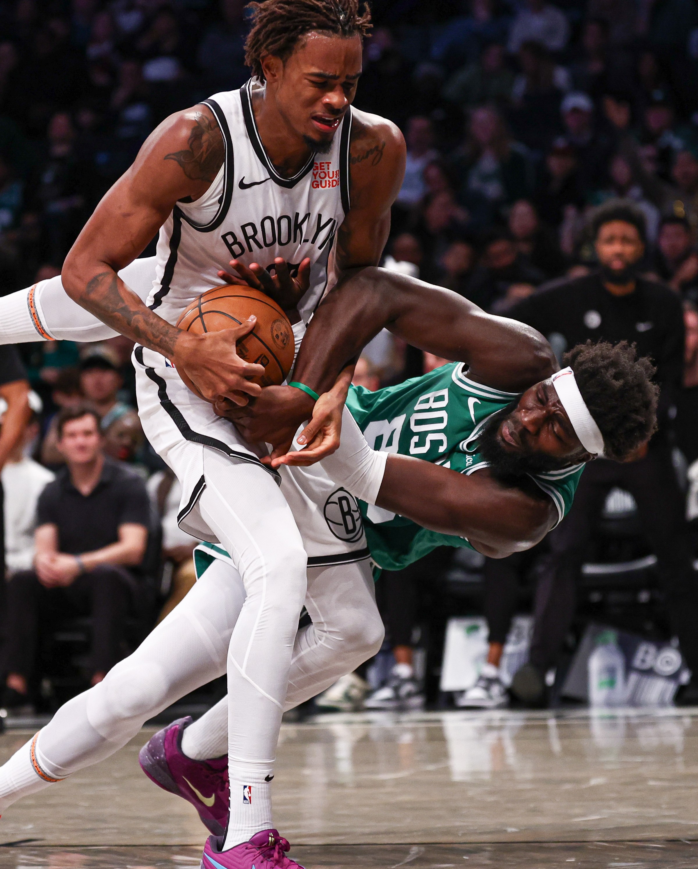 Nov 13, 2024; Brooklyn, New York, USA; Brooklyn Nets center Nic Claxton (33) rebounds against Boston Celtics center Neemias Queta (88) during the first half at Barclays Center. Mandatory Credit: Vincent Carchietta-Imagn Images