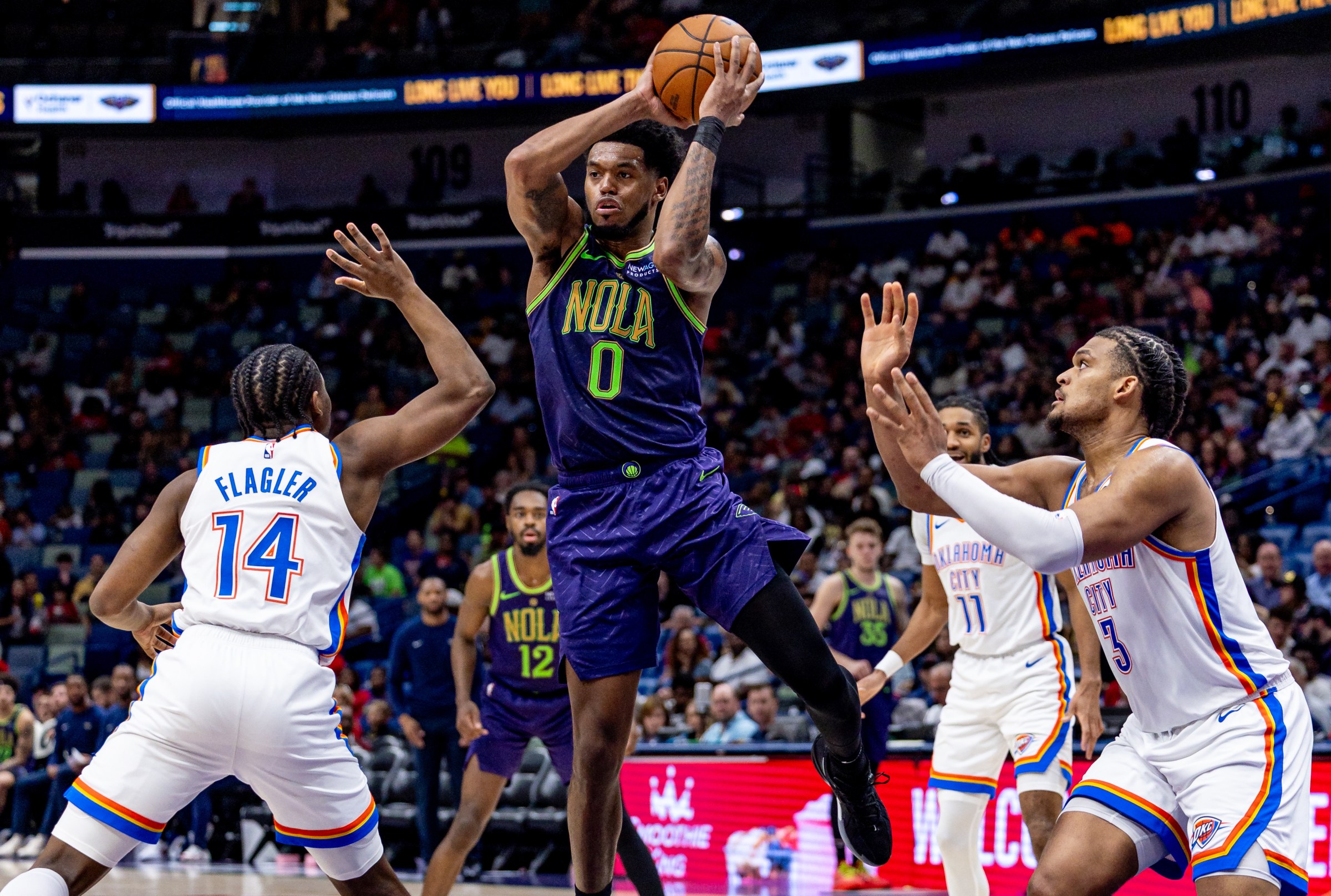 Apr 13, 2025; New Orleans, Louisiana, USA; New Orleans Pelicans forward Keion Brooks Jr. (0) passes the ball against Oklahoma City Thunder forward Adam Flagler (14) during the second half at Smoothie King Center. Mandatory Credit: Stephen Lew-Imagn Images