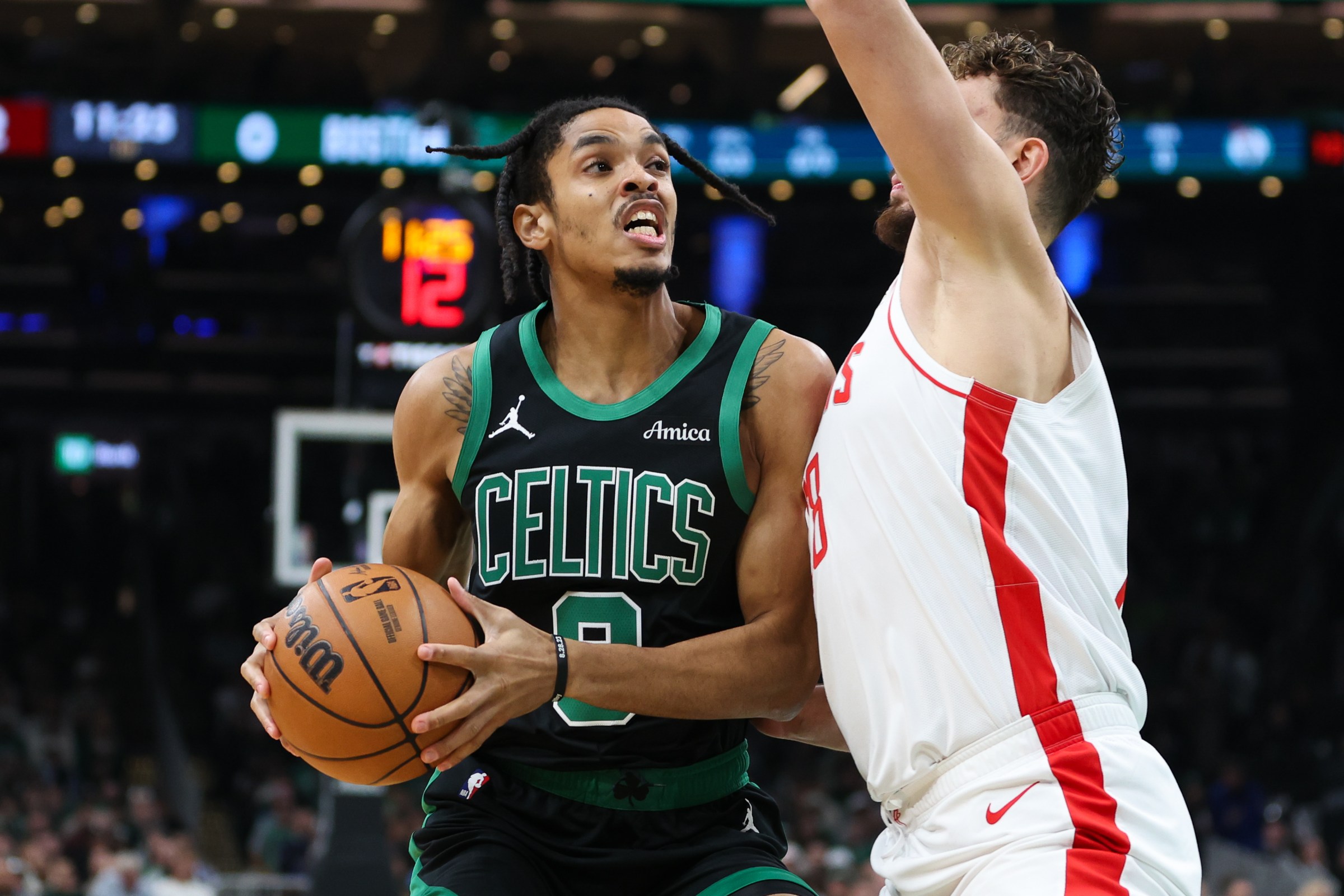 Nov 1, 2025; Boston, Massachusetts, USA; Boston Celtics forward Josh Minott (8) drives to the basket during the first half against the Houston Rockets at TD Garden. Mandatory Credit: Paul Rutherford-Imagn Images