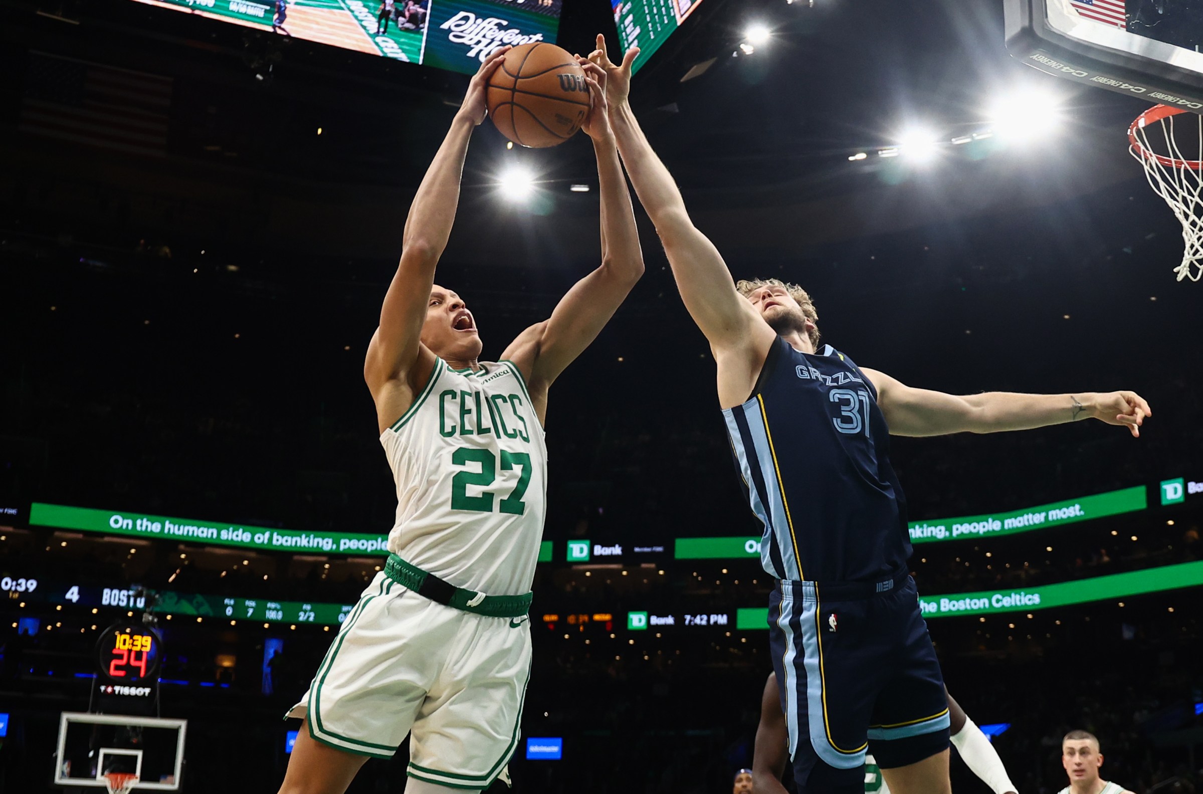 Nov 12, 2025; Boston, Massachusetts, USA; Boston Celtics guard Jordan Walsh (27) grabs a rebound away from Memphis Grizzlies center Jock Landale (31) during the first quarter at TD Garden. Mandatory Credit: Winslow Townson-Imagn Images