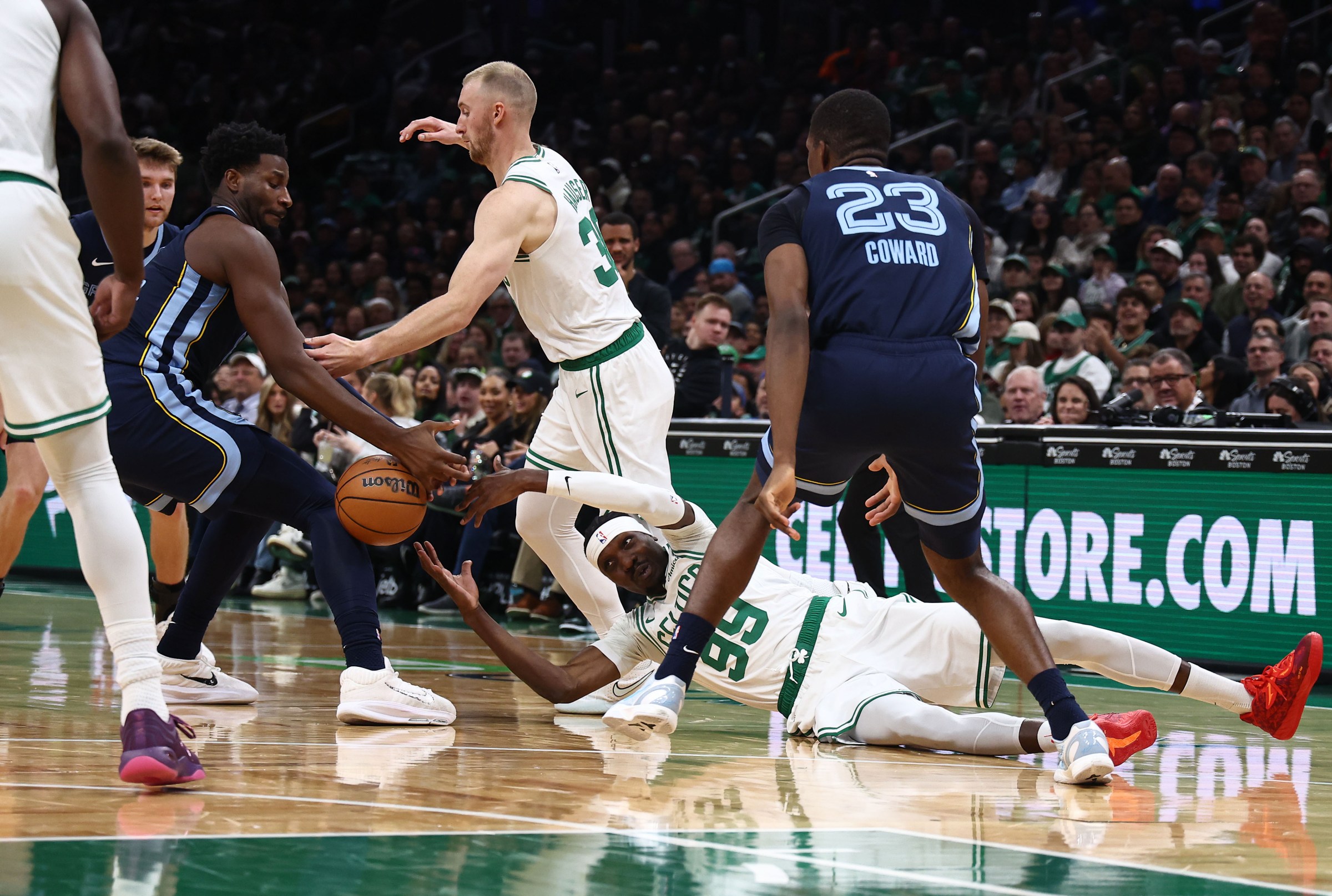Nov 12, 2025; Boston, Massachusetts, USA; Boston Celtics forward Chris Boucher (99) reaches for a loose ball with Memphis Grizzlies forward Jaren Jackson Jr. (8) during the second quarter at TD Garden. Mandatory Credit: Winslow Townson-Imagn Images