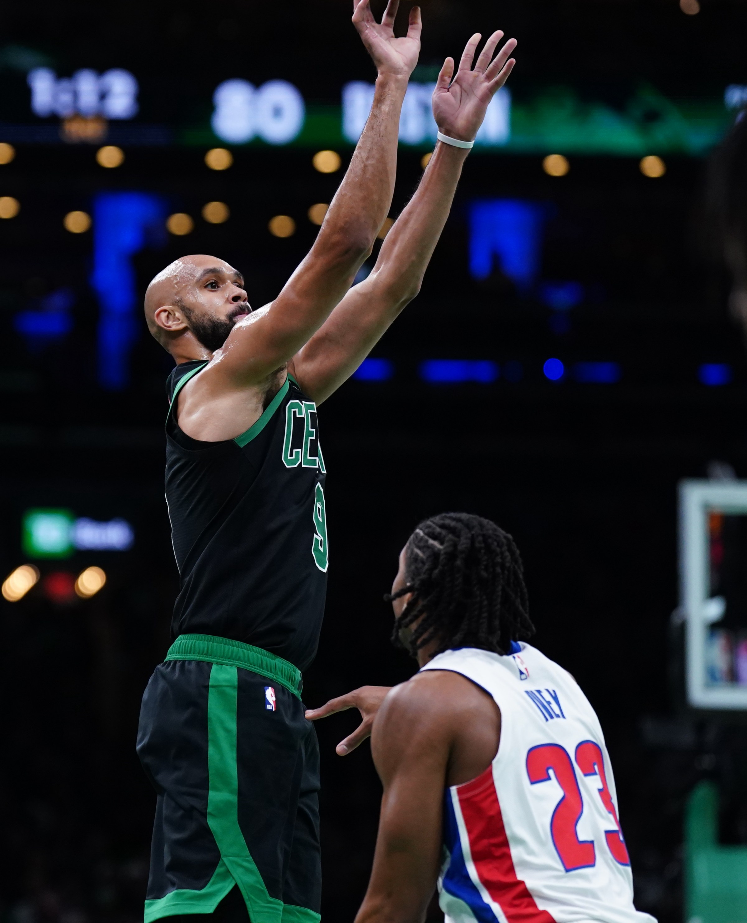 Nov 26, 2025; Boston, Massachusetts, USA; Boston Celtics guard Derrick White (9) shoots for three points against Detroit Pistons guard Jaden Ivey (23) in the second half at TD Garden. Mandatory Credit: David Butler II-Imagn Images