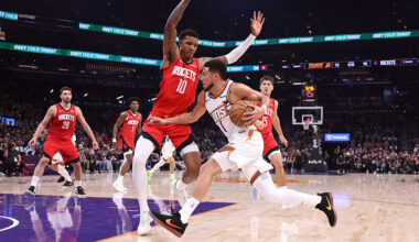 Devin Booker #1 of the Phoenix Suns goes to the basket against Jabari Smith Jr. #10 of the Houston ...