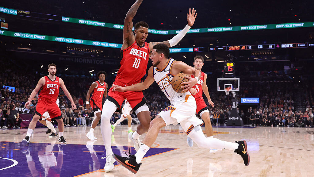 Devin Booker #1 of the Phoenix Suns goes to the basket against Jabari Smith Jr. #10 of the Houston ...