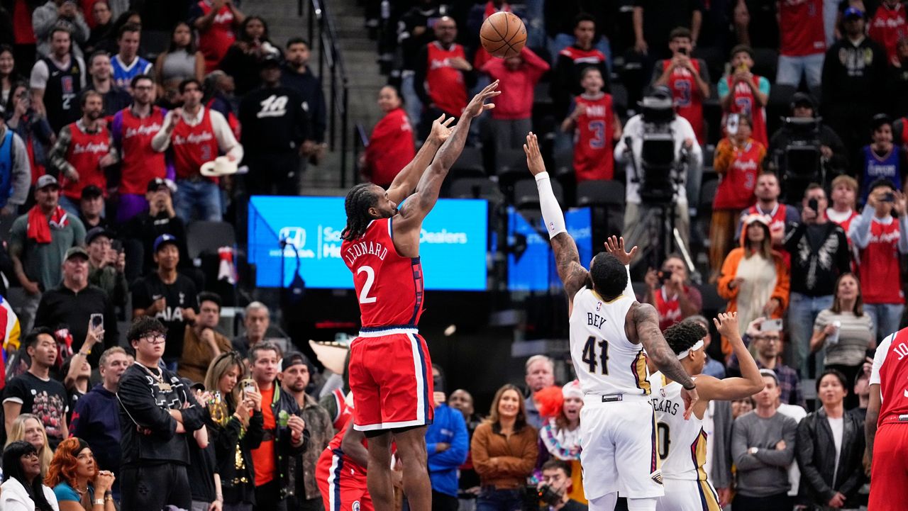 Los Angeles Clippers forward Kawhi Leonard, left, shoots and make a game-winning shot as New Orleans Pelicans guard Saddiq Bey defends during the second half of an NBA basketball game against Friday, Oct. 31, 2025, in Inglewood, Calif. (AP Photo/Mark J. Terrill)