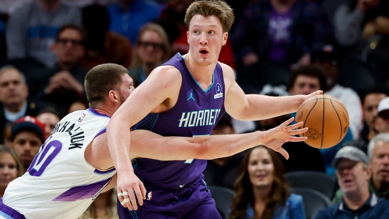 Charlotte Hornets guard Kon Knueppel, right, looks to pass against Utah Jazz guard Svi Mykhailiuk during the first half of an NBA basketball game in Charlotte, N.C., Sunday, Nov. 2, 2025. (AP Photo/Nell Redmond)