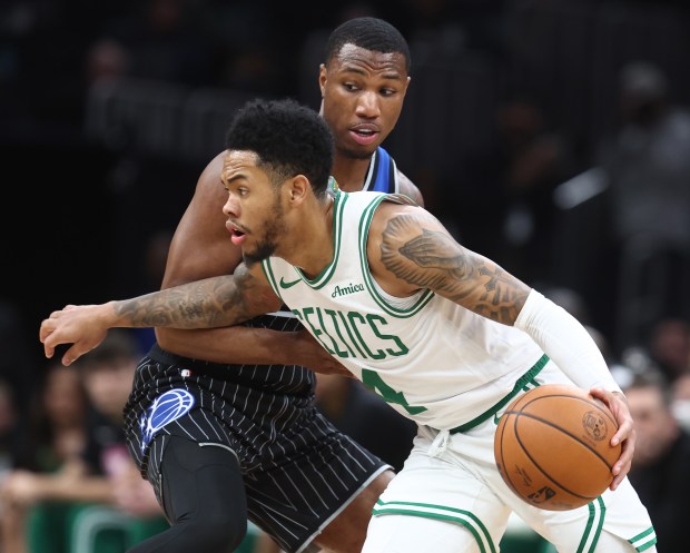 Boston Celtics guard Anfernee Simons drives past Orlando Magic's Jamal Cain during the second quarter of Sunday's game at the TD Garden. (Nancy Lane/Boston Herald)