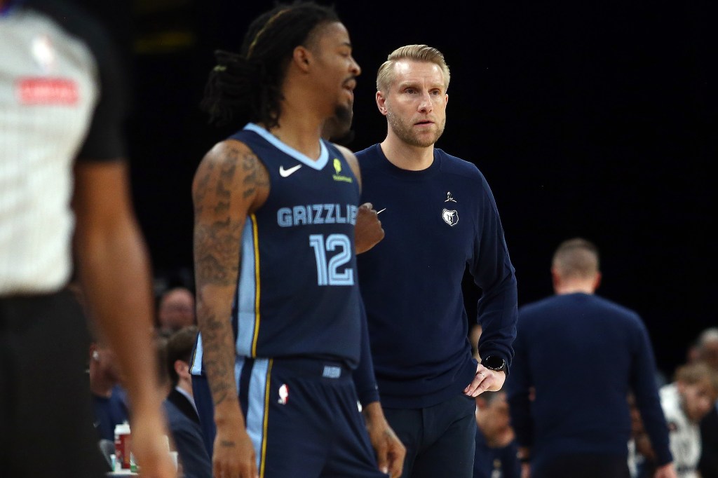 Memphis Grizzlies head coach Tuomas Iisalo watching Ja Morant (12) check into a game against the Detroit Pistons.