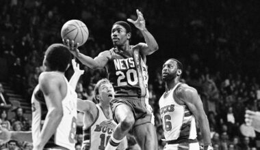 michael ray richardson, with the new jersey nets, drives to the basket with the ball in his right hand