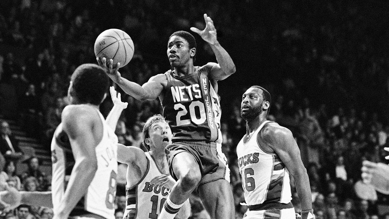 michael ray richardson, with the new jersey nets, drives to the basket with the ball in his right hand