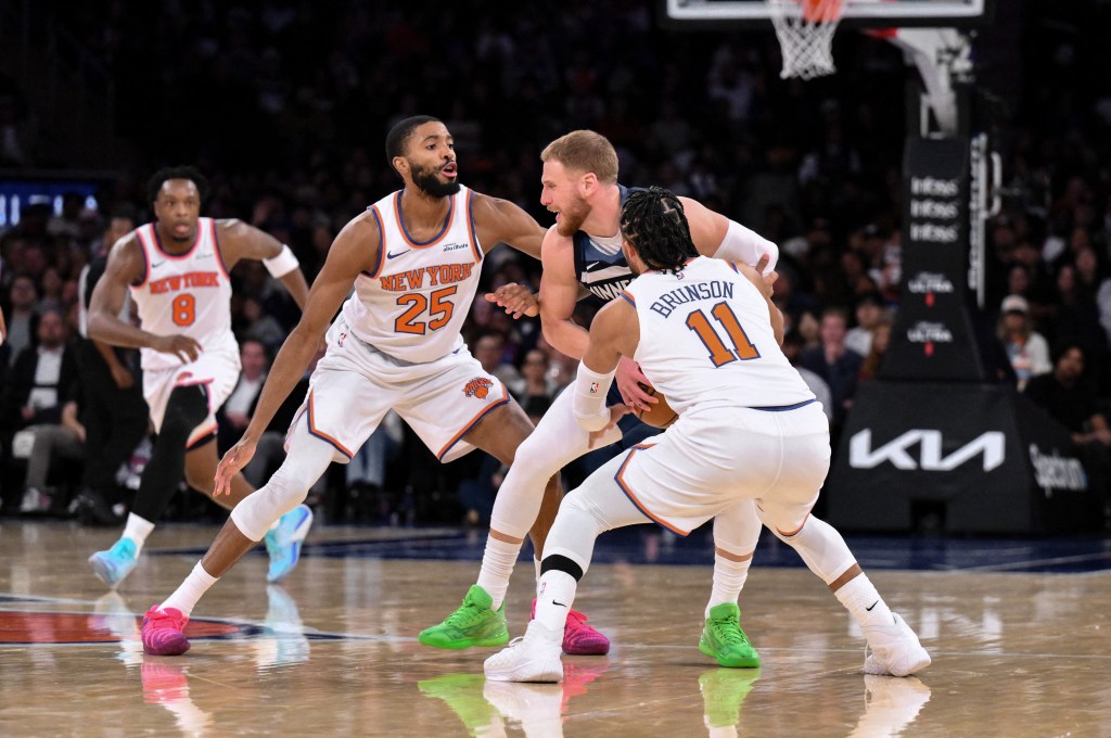 Minnesota Timberwolves guard Donte Divincenzo is double teamed by New York Knicks forward Mikal Bridges (25) guard Jalen Brunson (11).