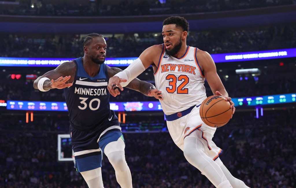 New York Knicks center Karl-Anthony Towns drives to the basket as Timberwolves Julius Randle defends.