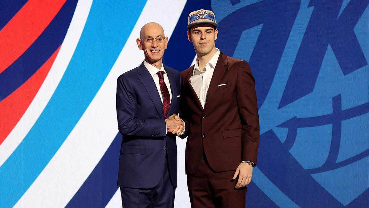 Nikola Topic poses for photos with NBA commissioner Adam Silver
