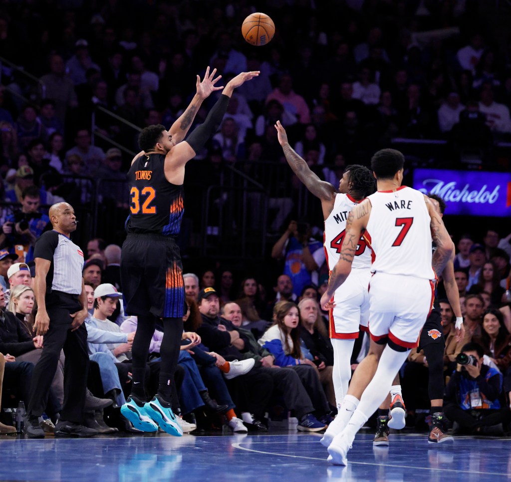 Karl-Anthony Towns shoots a three-point shot against the Miami Heat.