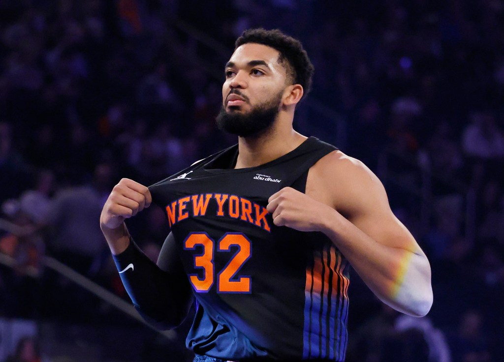 NBA player Karl-Anthony Towns stretches his jersey during a game.