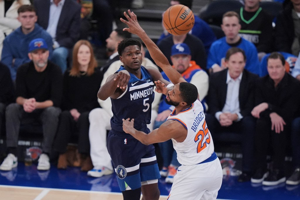 Minnesota Timberwolves' Anthony Edwards (5) passes over New York Knicks' Mikal Bridges (25).