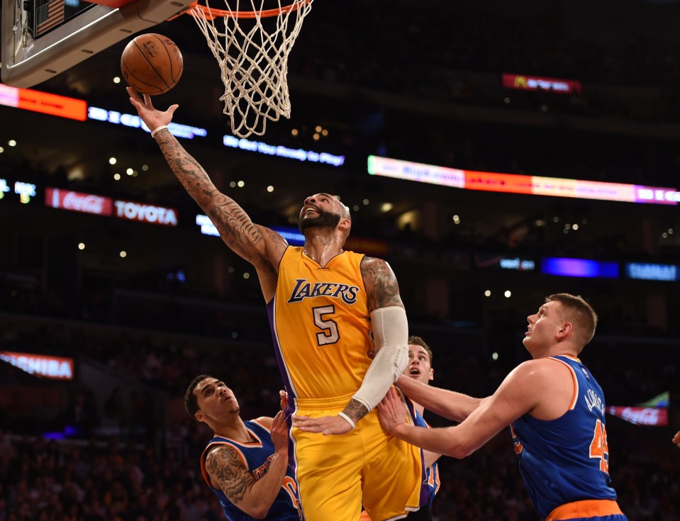 Carlos Boozer of the Los Angeles Lakers (C) scores against the New York Knicks at Staples Center in Los Angeles, California