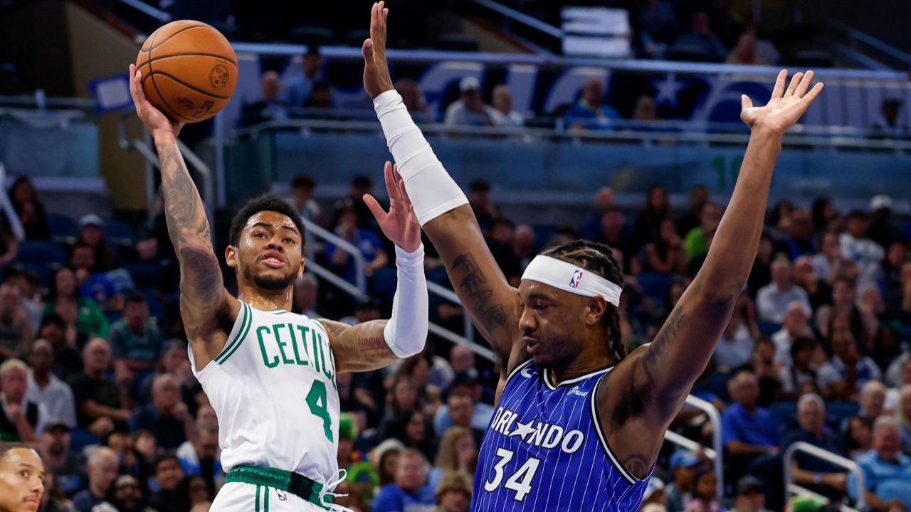 Celtics guard Anfernee Simons (4), who scored 25 points on Sunday night, shoots and is fouled by Magic center Wendell Carter Jr. (34). (AP Photo/Kevin Kolczynski)