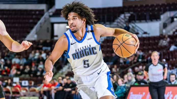 Ethan Thompson of the Magic drives to the hoops in an NBA game.