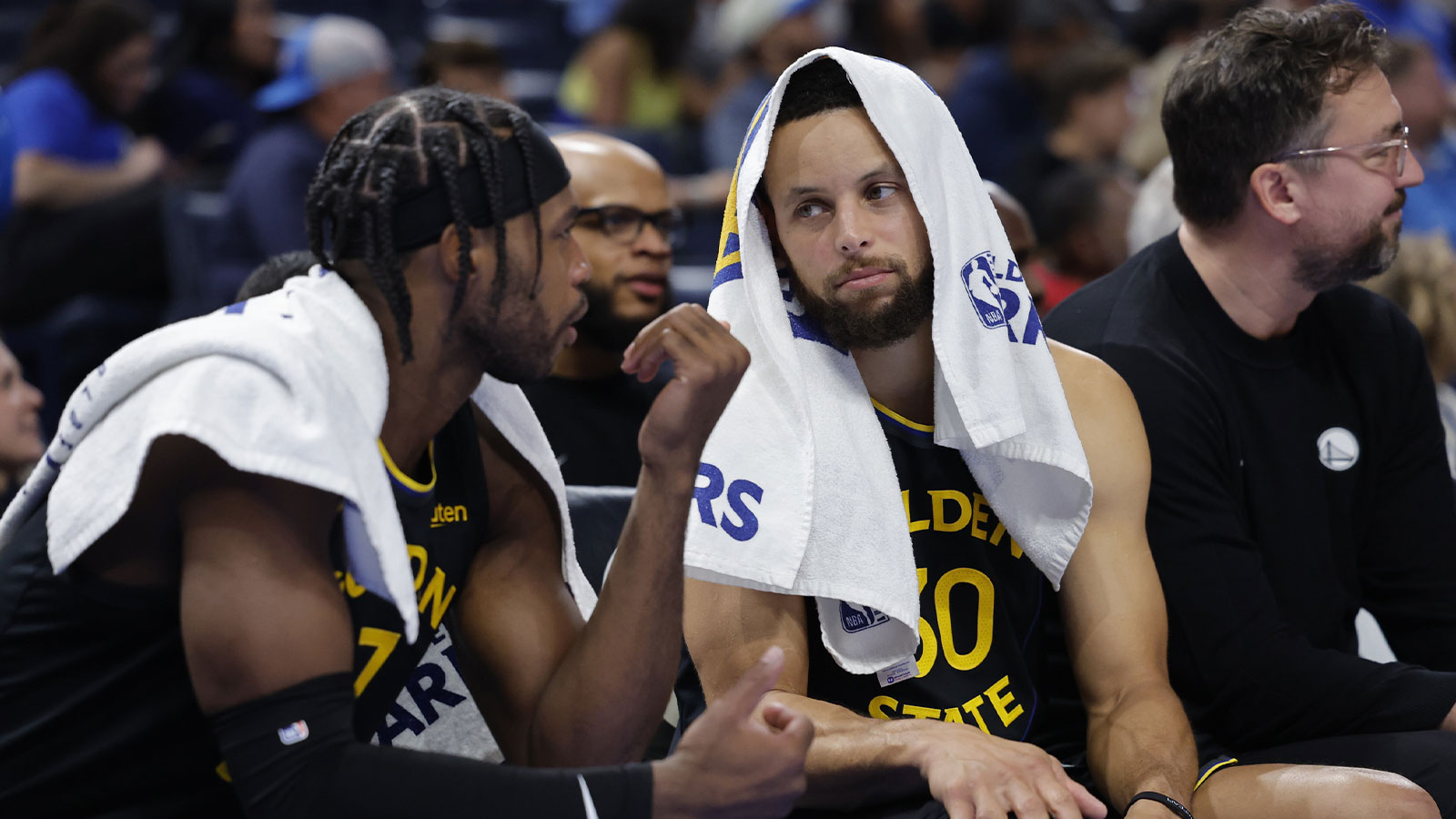 Golden State Warriors guard Buddy Hield (7) and guard Stephen Curry (30) talk on the bench during the second half against the Oklahoma City Thunder at Paycom Center. 