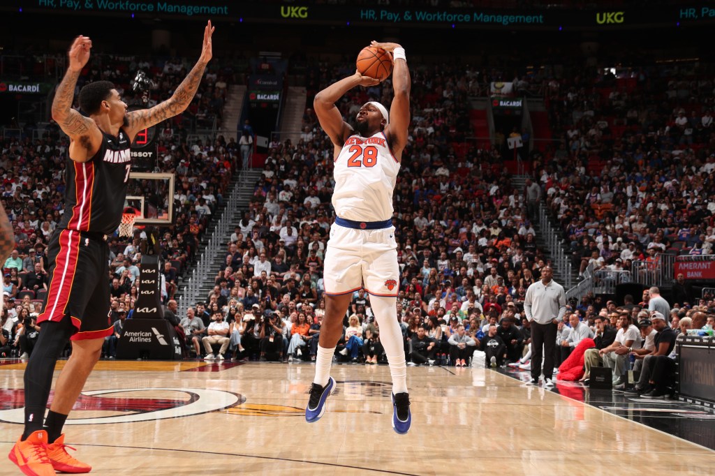 Guerschon Yabusele #28 of the New York Knicks shoots a three point basket during the game against the Miami Heat on October 26, 2025 at Kaseya Center in Miami, Florida.