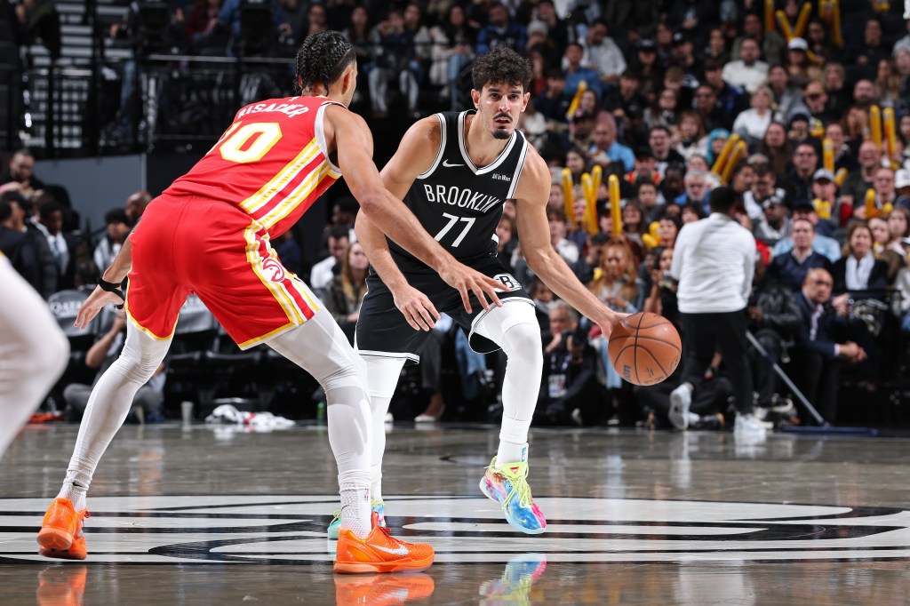Ben Saraf #77 of the Brooklyn Nets dribbles the ball against the Atlanta Hawks.