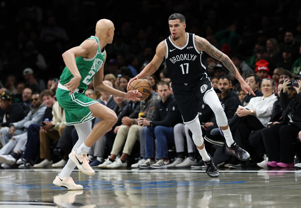 Michael Porter Jr. #17 of the Brooklyn Nets drives against Jordan Walsh #27 of the Boston Celtics.