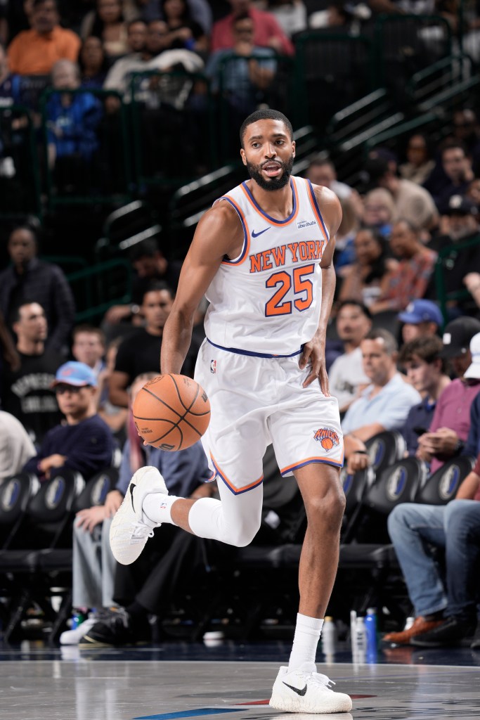 Mikal Bridges of the New York Knicks dribbles the ball during a game.