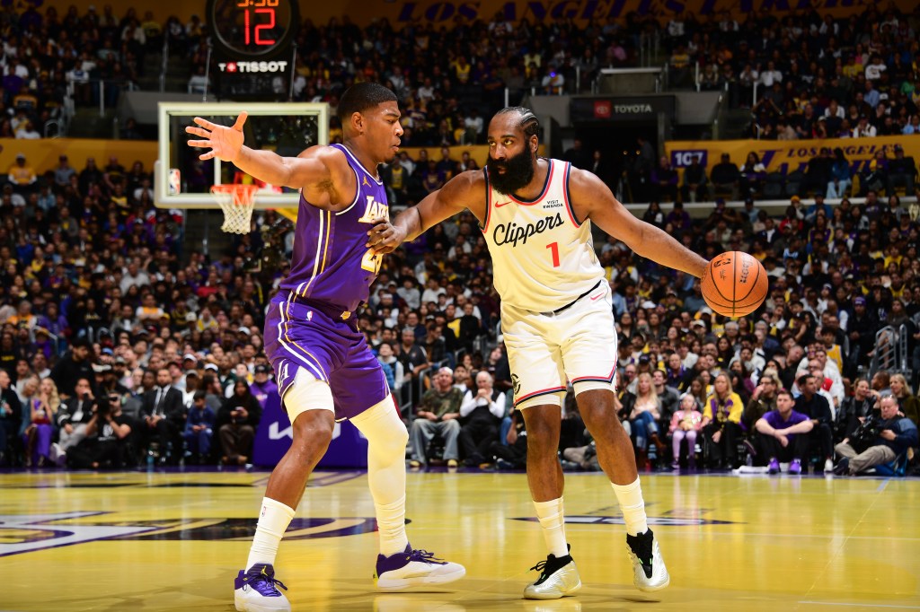 James Harden of the LA Clippers dribbles the ball against a Los Angeles Lakers player.