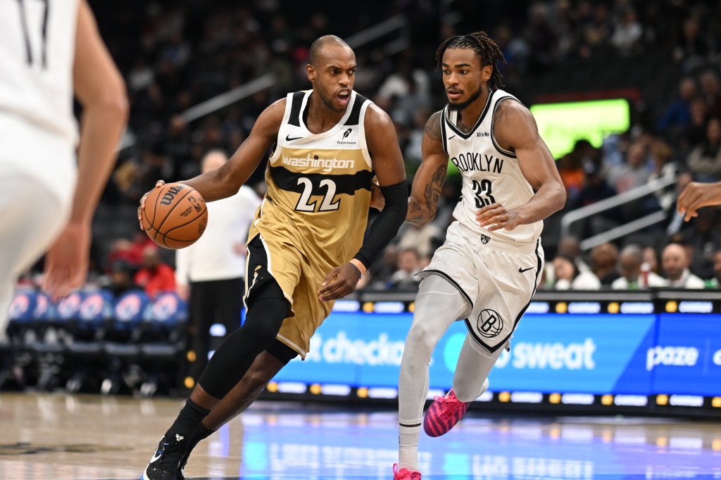 Washington Wizards forward Khris Middleton (22) dribbles the ball in front of Brooklyn Nets center Nic Claxton (33).