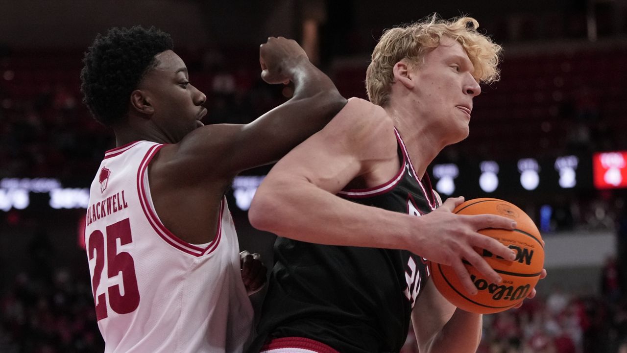 SIUE's Arnas Sakenis grabs a rebound in front of Wisconsin's John Blackwell during the first half of an NCAA college basketball game Monday, Nov. 17, 2025, in Madison, Wis.