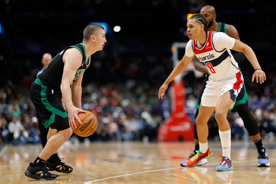 Oct 24, 2024; Washington, District of Columbia, USA; Boston Celtics guard Payton Pritchard (11) dribbles the ball ad Washington Wizards forward Kyshawn George (18) in the first half at Capital One Arena. Mandatory Credit: Geoff Burke-Imagn Images