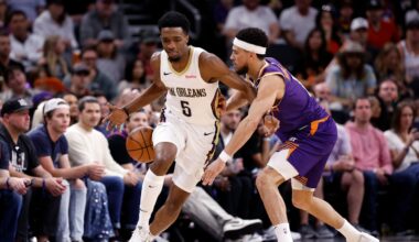 Phoenix Suns guard Devin Booker pokes the ball away from new Orleans Pelicans forward Herbert Jones.