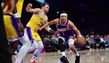 Phoenix Suns guard Devin Booker (1) moves to the basket against Los Angeles Lakers guard Luka Doncic (77) during the first half at Crypto.com Arena. Mandatory Credit: Gary A. Vasquez-Imagn Images