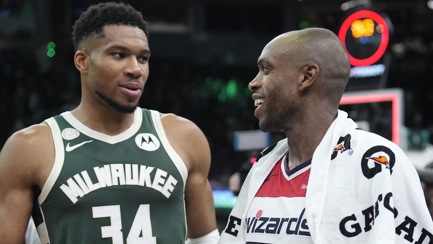 Oct 22, 2025; Milwaukee, Wisconsin, USA; Milwaukee Bucks forward Giannis Antetokounmpo (34) and Washington Wizards forward Khris Middleton (22) former teammates talk to each other after their game at Fiserv Forum. Mandatory Credit: Michael McLoone-Imagn Images