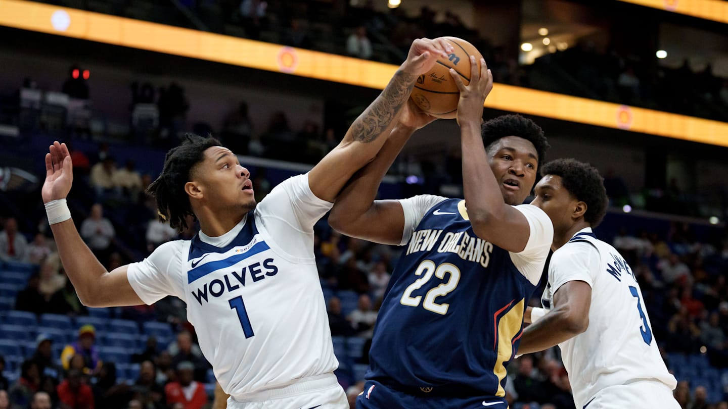 Dec 2, 2025; New Orleans, Louisiana, USA; Minnesota Timberwolves guard/forward Terrence Shannon Jr. (1) and forward Jaden McDaniels (3) defend against New Orleans Pelicans center Derik Queen (22) during the first half at Smoothie King Center. Mandatory Credit: Matthew Hinton-Imagn Images