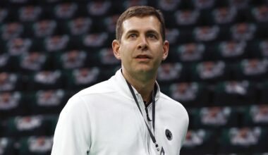 Boston Celtics forward Jayson Tatum (0) and guard Jaylen Brown (7) celebrate with the Larry O’Brien Trophy .