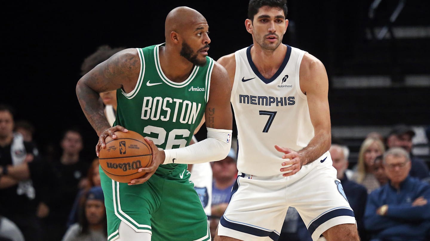 Oct 8, 2025; Memphis, Tennessee, USA; Boston Celtics forward Xavier Tillman Sr. (26) handles the ball as Memphis Grizzlies forward Santi Aldama (7) defends during the fourth quarter at FedExForum. Mandatory Credit: Petre Thomas-Imagn Images