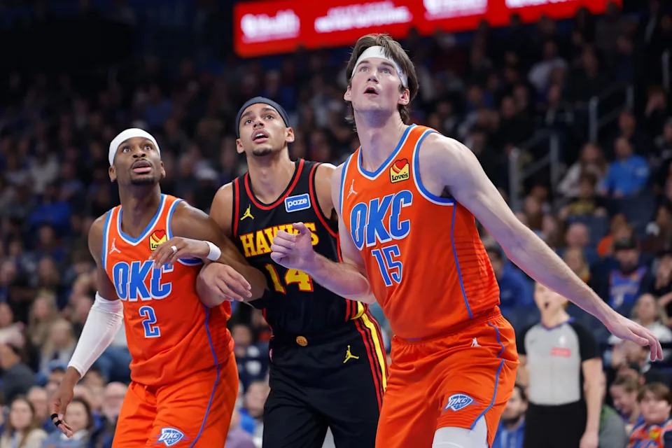 Dec 29, 2025; Oklahoma City, Oklahoma, USA; Atlanta Hawks forward Asa Newell (14), Oklahoma City Thunder guard Shai Gilgeous-Alexander (2) and center Branden Carlson (15) watch for a rebound during the first half at Paycom Center. Mandatory Credit: Alonzo Adams-Imagn Images
