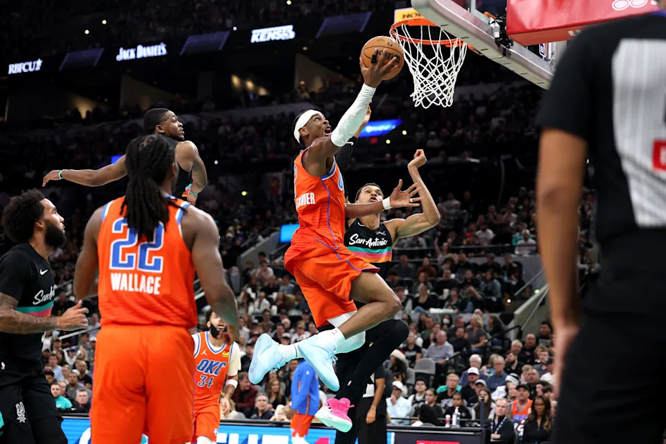 SAN ANTONIO, TEXAS - DECEMBER 23: Shai Gilgeous-Alexander #2 of the Oklahoma City Thunder shoots a layup during the second quarter of the game against Victor Wembanyama #1 of the San Antonio Spurs at Frost Bank Center on December 23, 2025 in San Antonio, Texas. (Photo by Kenneth Richmond/Getty Images)
