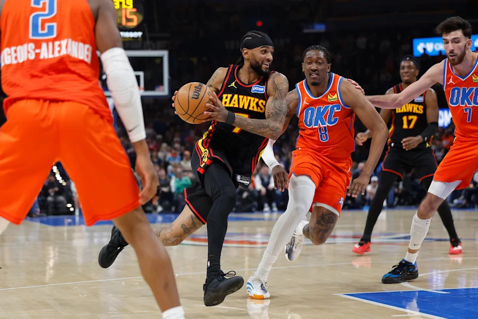 Dec 29, 2025; Oklahoma City, Oklahoma, USA; Atlanta Hawks guard Nickeil Alexander-Walker (7) drives to the basket beside Oklahoma City Thunder guard Jalen Williams (8) during the first half at Paycom Center. Mandatory Credit: Alonzo Adams-Imagn Images