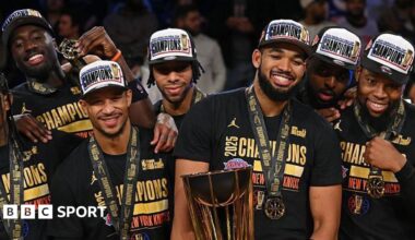 Karl-Anthony Towns holds the NBA Cup trophy besides his team-mates after the New York Knicks beat the San Antonio Spurs